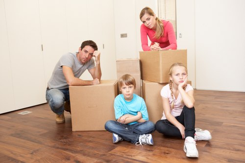 Professional movers handling furniture in a Hither Green property