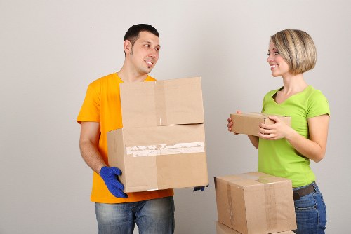 Professional movers assisting with a flat move near Hither Green station area