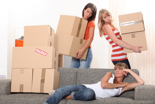 Professional movers handling household items during a Hither Green relocation